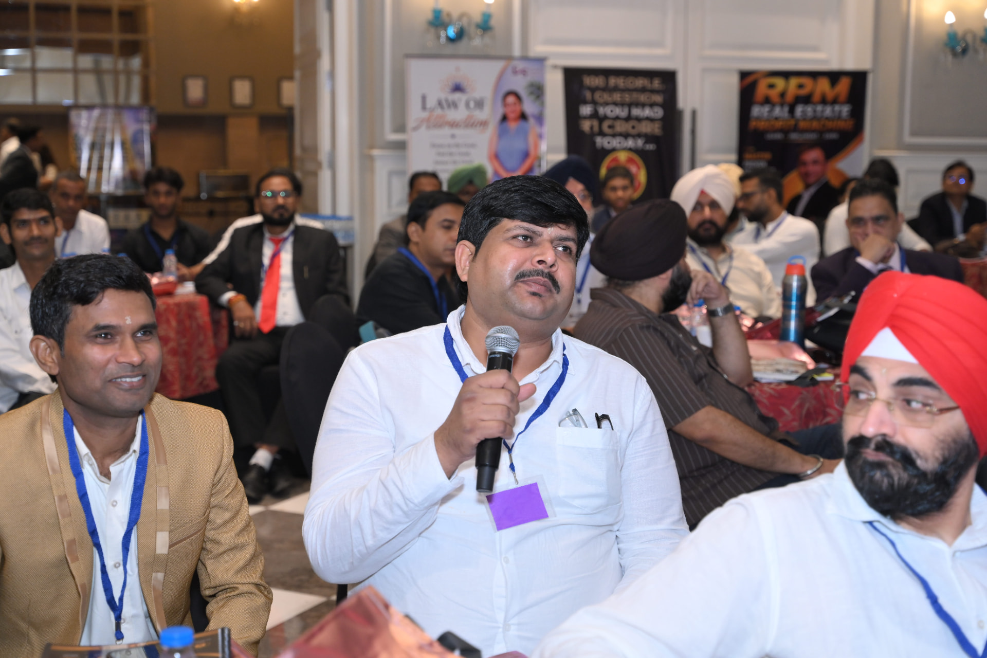 An attendee asking a question on the microphone