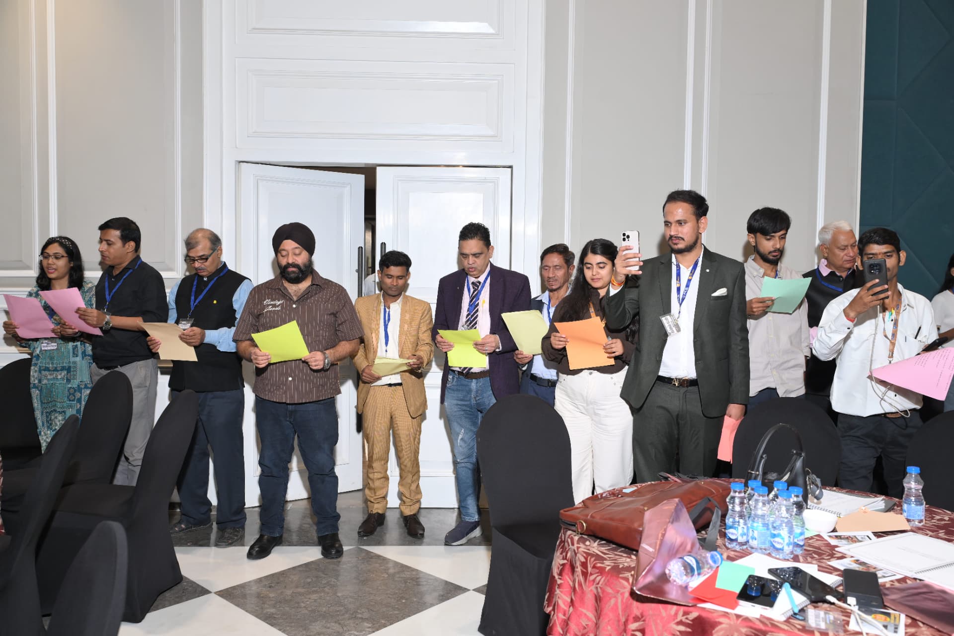 Attendees standing and reading their commitment sheets aloud
