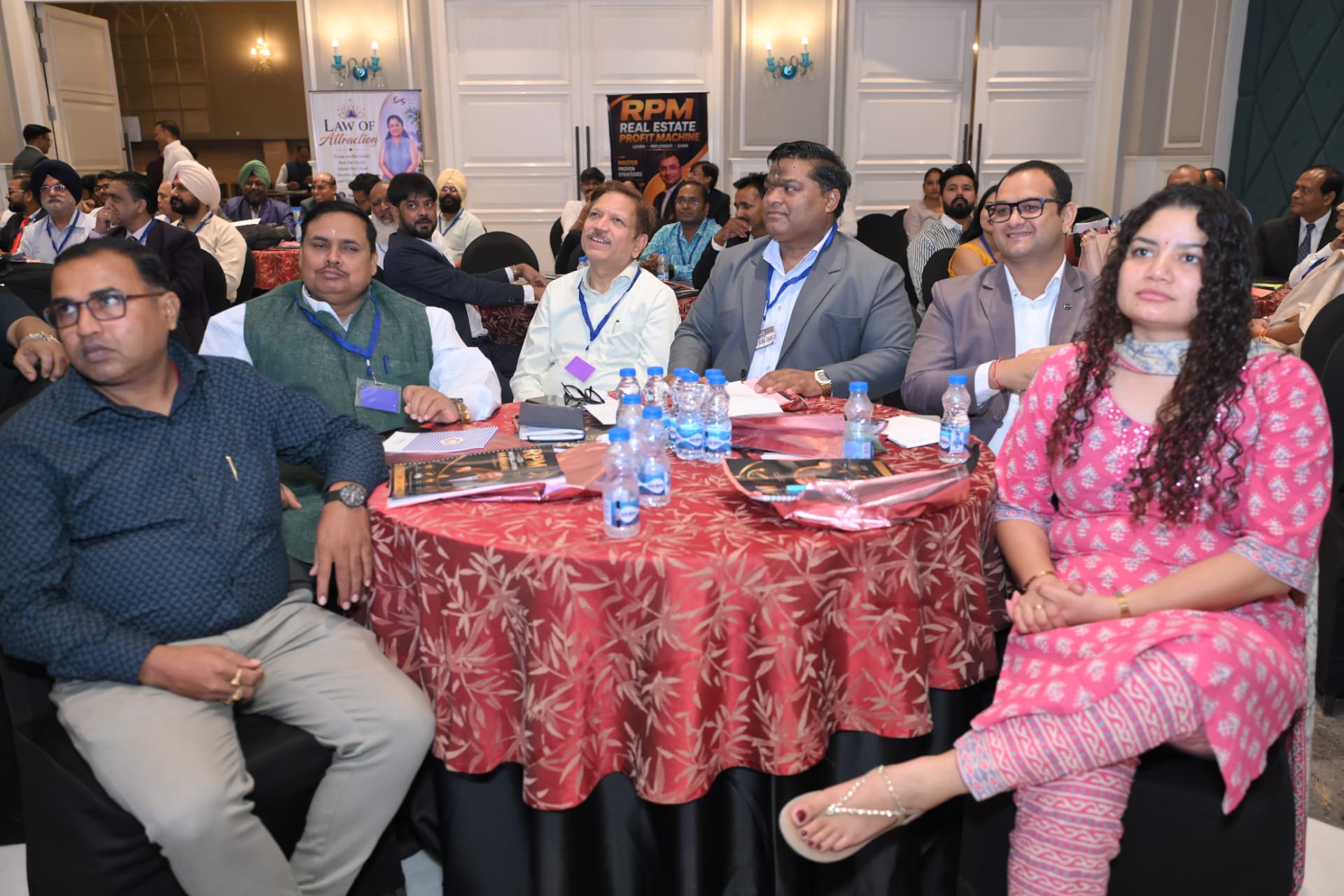 Attendees seated at a table listening during the workshop